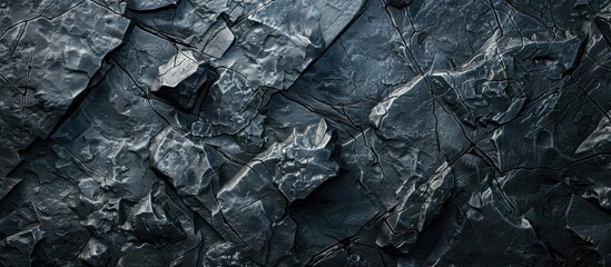 A blank textured dark grey stone wall in a cave serves as an abstract background with attractive patterns and space for a banner or wallpaper with a close up image of copy space