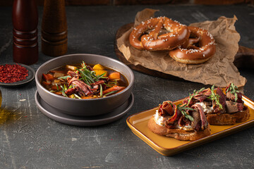 Portion of smoked brisket rustic stew soup and bruschettas