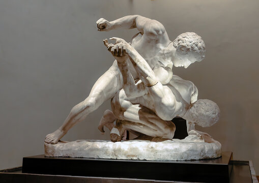 Uffizi Gallery, Florence, Italy - June 20, 2024:  "The Wrestlers" ("Uffizi Wrestlers", "Pankrationists") is an ancient Roman marble sculpture depicting a fight between two pankrationists.