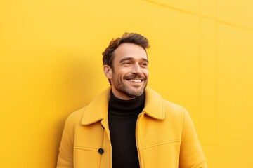 Obraz premium Portrait of a blissful man in his 30s wearing a thermal fleece pullover while standing against soft yellow background