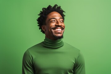 Fototapeta premium Portrait of a cheerful afro-american man in his 30s wearing a classic turtleneck sweater in soft green background