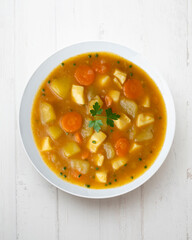 Squid stew with potatoes and vegetables. Top view table with  decoration.