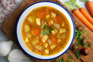 Squid stew with potatoes and vegetables. Top view table with  decoration.