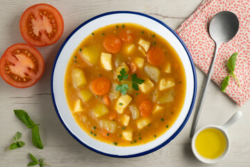 Squid stew with potatoes and vegetables. Top view table with  decoration.