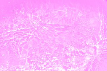 Pink water bubbles on the surface ripples. Defocus blurred transparent pink colored clear calm water surface texture with splash and bubbles. Water waves with shining pattern texture background