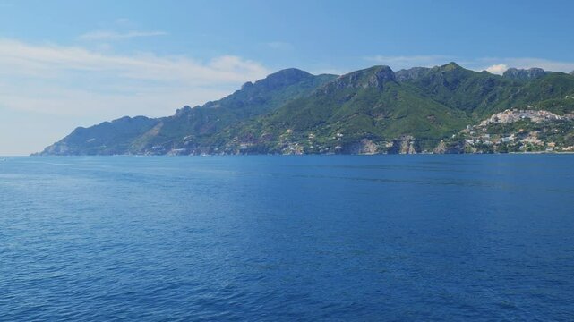 Salerno, Italy. Seascape of ​​the Amalfi Coast, from the port of Salerno to Vietri sul Mare, Raito and Albori. Taken from a moving boat sailing along the Amalfi Coast. Real time 4K pan video.