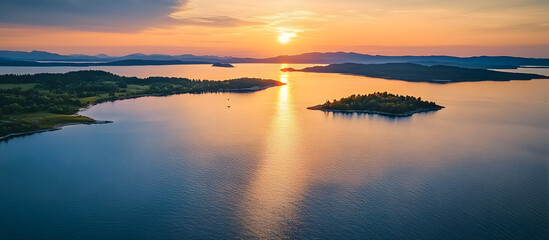 Obraz premium Aerial drone shot of a serene lake coast at sunset with islands and a clear view ahead ideal for use as a copy space image