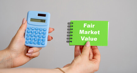 Fair Market Value concept. Price an asset would sell for on the open market when certain conditions are met. Business and finance. Calculator and notebook in hands
