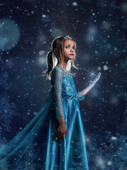 Young girl snow princess. Mystery fantasy girl in blue lush dress. Art background winter and snow.