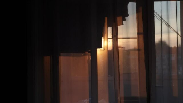 Transparent tulle at sunset close up, clothes hanging and drying on the balcony. Cozy home background