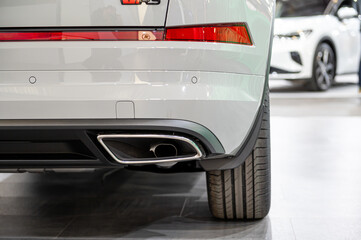 Detail of a luxury car exhaust showcasing modern design at an auto show