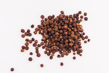 Close up shot of the black pepper on the white background. Spice