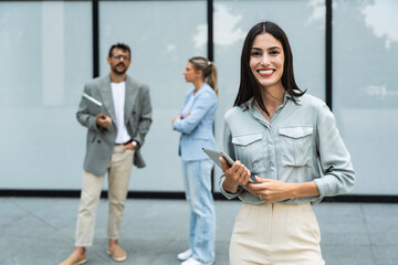 Portrait of happy smiling confident female leader businesswoman standing outside the modern office...