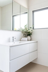 Fototapeta premium White bathroom cabinet with sink and mirror, wall mounted vanity for the powder room or primary closet in an Australian home, stylish interior design, minimalistic style, product photography.