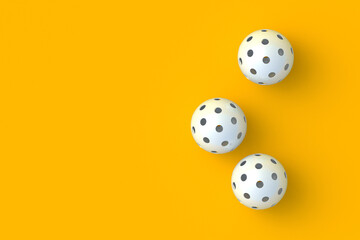Scattered pickleball balls on orange background. Sports equipment. Hobby and leisure games. Top view. Space for text. 3d render