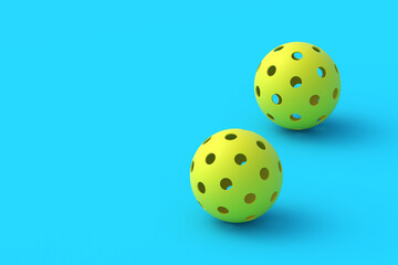 Two pickleball balls on blue background. Sports equipment. Hobby and leisure games. Copy space. 3d render