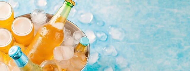 Bottles of beers in ice bucket taken from the top, background with a copy space area.  Oktoberfest and St. Patrick's day celebration in a pub or bar. Card, banner, poster, flyer with copy space