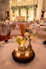 Wooden table decoration in a wedding hall with candles