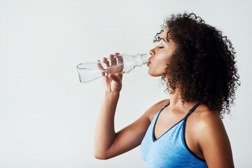 Woman, thirsty and drinking water in studio with fitness for hydration, break and tired of exercise...