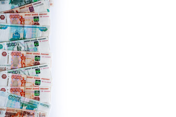 a lot of money Russian rubles in denominations of five thousand rubles and one thousand rubles on a white background with space for text