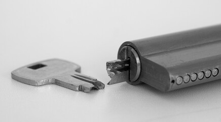 Close-up of broken key and lock with half key inside