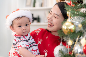 Little child with parents joyful moment celebrating together at home during the Christmas season
