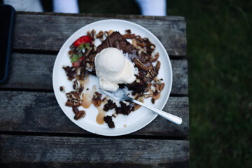 Basic homemade brownie or chocolate cake. Scoop of ice cream on a fresh stack of fresh brownies. High quality photo
