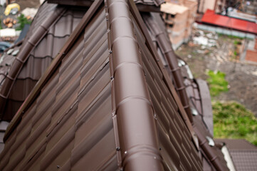 Close-Up of Modern Brown Metal Roof with Urban Background