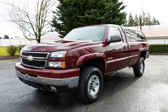 Portland, OR, USA - Jan 28, 2024 - 2006 Burgundy Chevrolet Chevy 3500 Silverado LT Chevy classic pickup truck American 4X4 SUV off-road vehicle exterior. High quality picture for download.