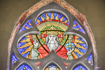 Colorful stained glass window featuring religious figure