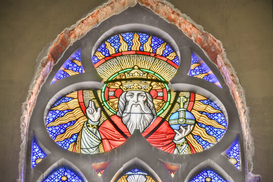 Colorful stained glass window featuring religious figure