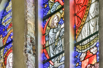 Colorful stained glass window with angelic depiction