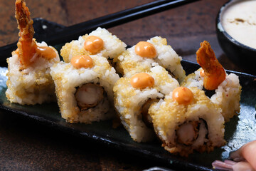  Japanese seafood sushi set on stone table, close-up.
