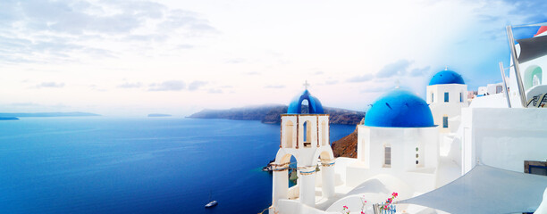 traditional greek village Oia of Santorini, with blue domes against sea and caldera, Greece, web...