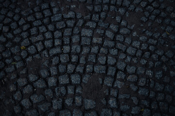 Cobblestone pavement Stone road in the street of old town. Sunlight on cobblestone road in the morning. Old stone texture. High quality photo