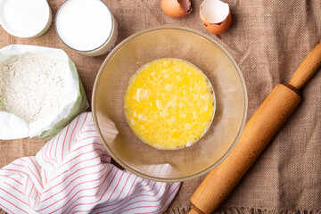 Home Baking - whisking eggs for homemade cake. Recipe with eggs, wholegrain flour, sugar and kefir.