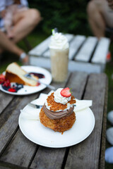 Summer dessert with fresh raspberry and mascarpone cheese and biscuit on a wooden board. Healthy food, vegan, sugar, gluten and lactose free. Berry dessert, cheesecake
