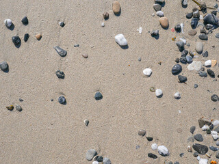 Background of colorful pebbles on the sand beach