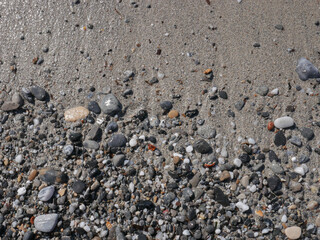 Background of colorful pebbles on the sand beach