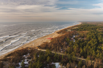 Aerial view of the Baltic Sea shore line near Klaipeda city, Lithuania. Beautiful sea coast on chilly and snowy winter day.