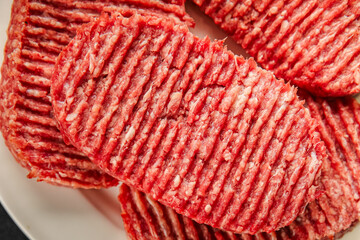 Raw cutlet fresh ground meat beef burger, pork, chicken, turkey second course dish fresh delicious gourmet food background on the table rustic food top view copy space