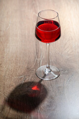 Red wine glass on a wooden table