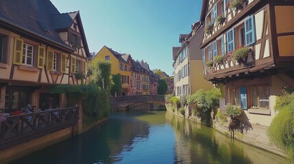 A picturesque canal runs through the heart of a quaint European town, lined with charming half-timbered houses, creating a serene and idyllic atmosphere.