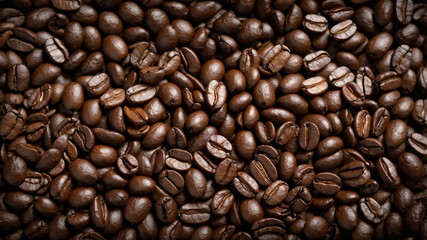 Close-up image of roasted coffee beans showcasing their rich, dark brown color and glossy texture.