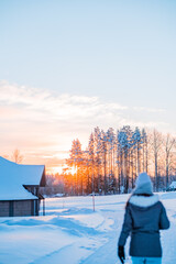 Snow Covered Forest Landscape During a Rising Sun in the Morning Shining on a Person