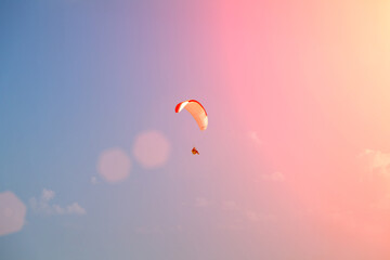 Paragliding. A paraglider flies in the air on a paraglider.