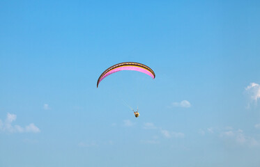 Paragliding. A paraglider flies in the air on a paraglider.