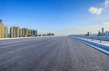 Asphalt highway road with modern city buildings scenery. car advertising background.