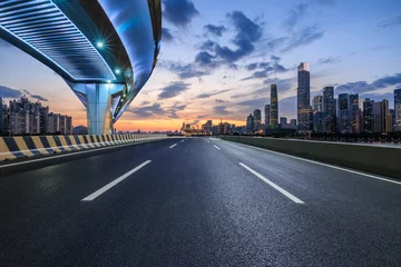  Asphalt highway road and bridge with modern city buildings at night in Guangzhou. car advertising background. © ABCDstock