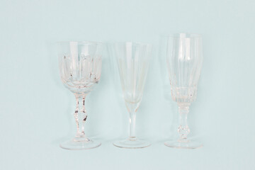 Three vintage crystal glasses on a blue background.